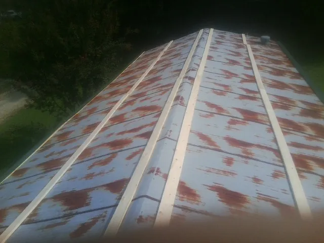 Rusted metal roof panels with new wood purlins before replacement — Storm Damage Roof Repair in Mc Arthur by Roofing Brothers