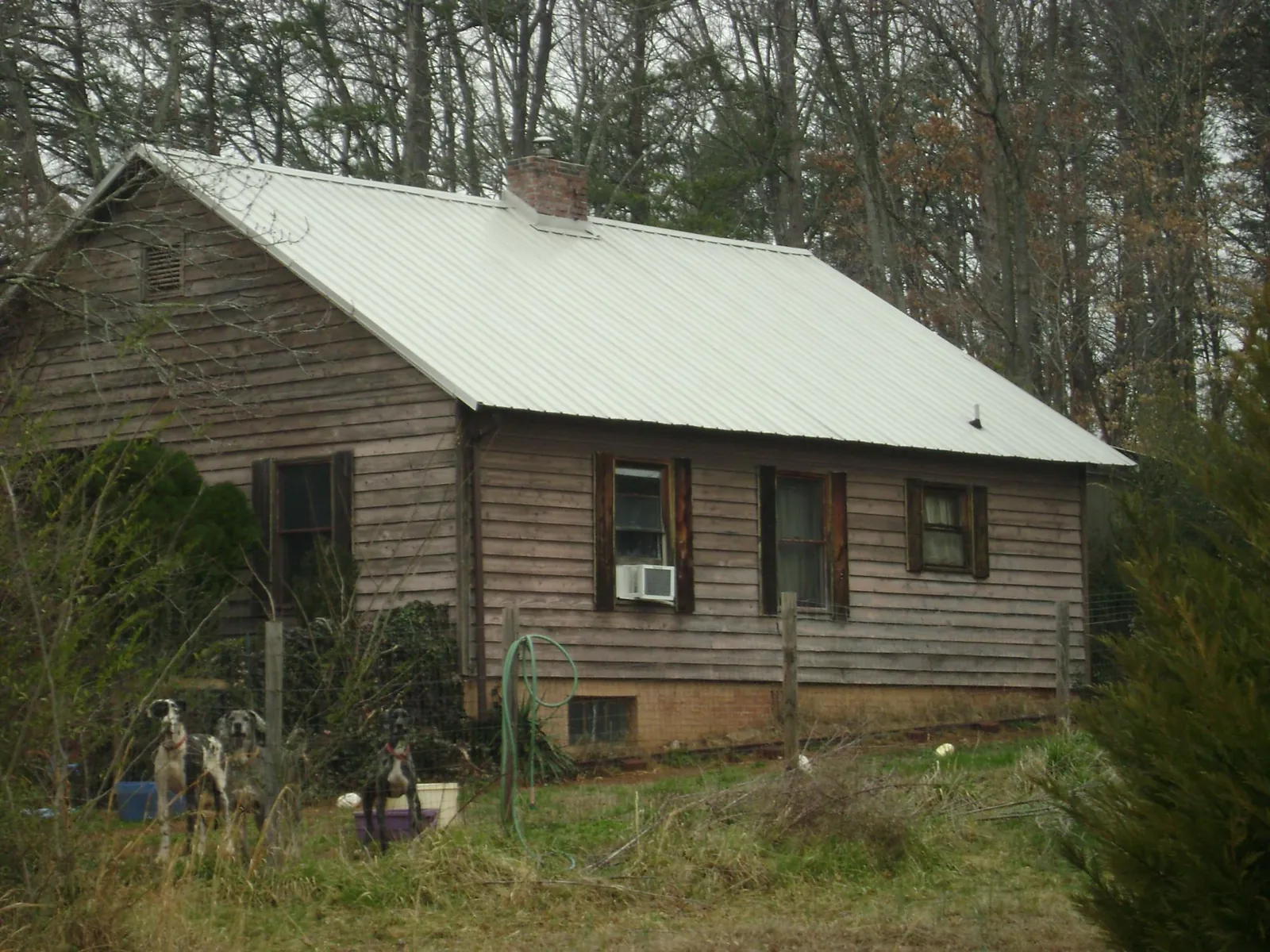 White metal roof on an old wood sided farmhouse, from a Metal Roof Installation job in Mc Arthur